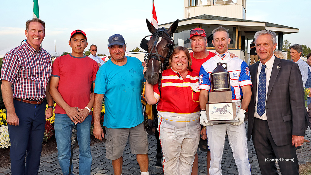 Little Brown Jug champion Its My Show in the winner's circle with his connections
