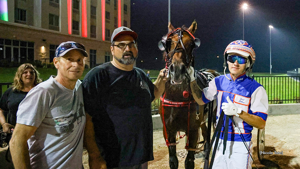 JAcob Cutting with Dan Patch Pace winner Hezzz A Wise Sky, trainer John Filomeno and Cutting's dad Darryl 