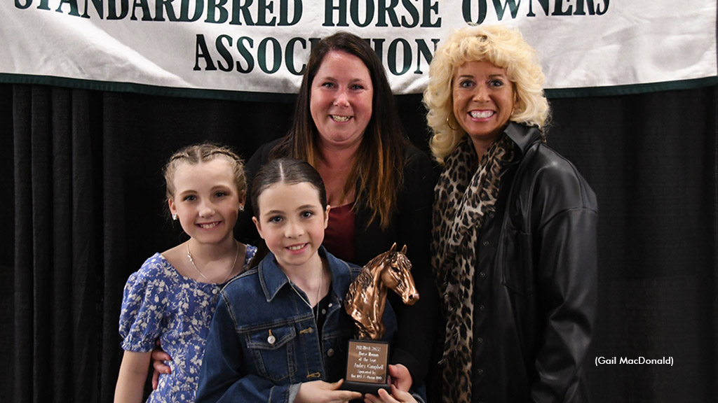 Jeniffer Evens (right) presents the Horsewoman of the Year Award to Ambyr Campbell (centre) also in the picture are daughters Brielle and Myla.