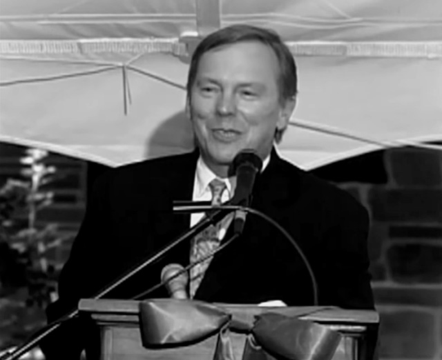 A man in a suit at a podium