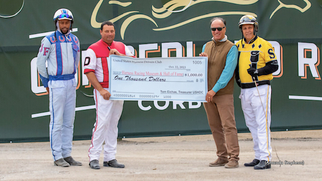 Jafari Frazier, Tony Dinges and Dein Spriggs with Ted Nicholson in the winner’s circle for the USHDC presentation to the Harness Racing Museum