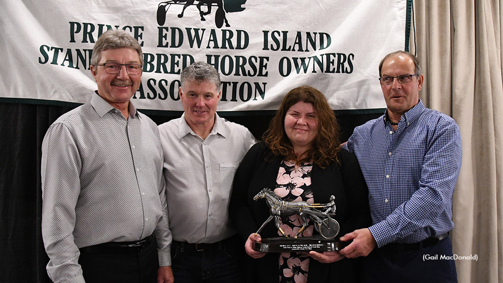 Dr. Kathleen MacMillan presents the 2022 Atlantic Vet College Horse of the Year Award to owners Gordon MacLeod (far left) Blain Thibeau and Eddie Doucette.