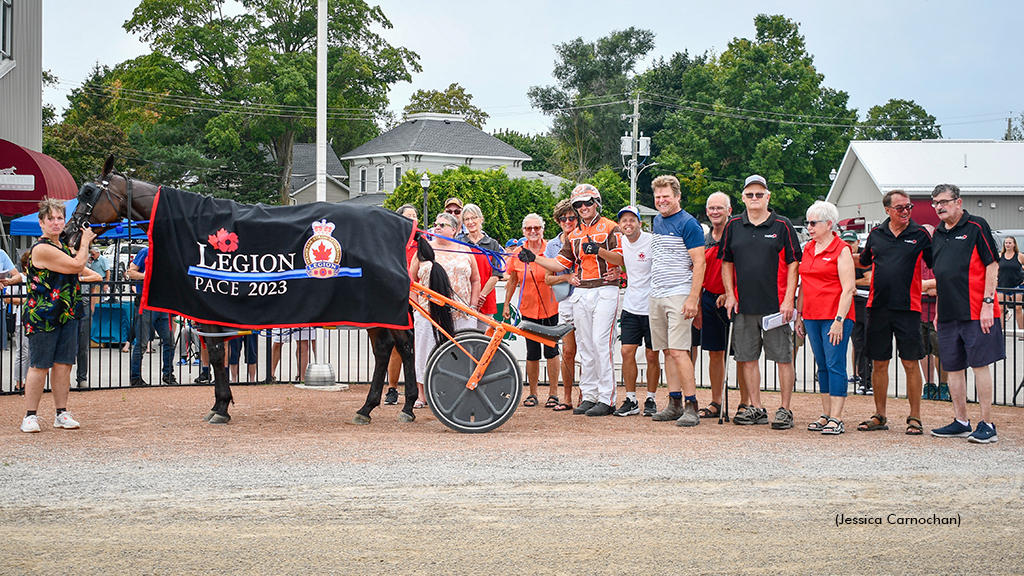 Meilleur Fromage and driver Tyler Borth with Legion members in the winner's circle at Clinton Raceway
