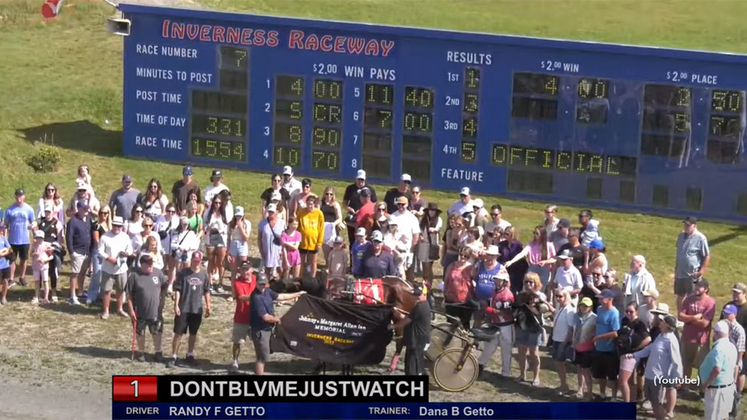 Dontblvmejustwatch in the winner's circle at Inverness Raceway