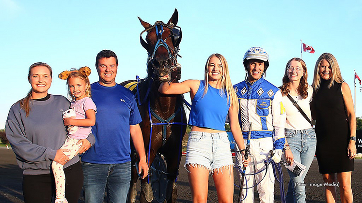 Paige Austin holding Hasty Bid in the winner's circle at Woodbine Mohawk Park