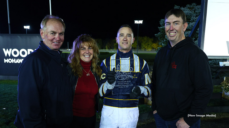 Shawn Steacy in the winner's circle after Sylvia Hanover's Breeders Crown victory