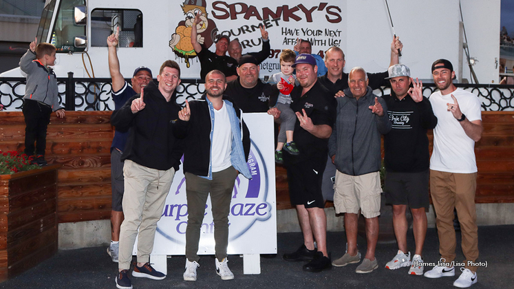 Fans pose beside a food truck at The Meadowlands
